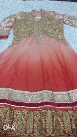 Anarkali peach and golden in colour with red