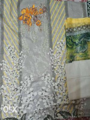Gray, White, Orange, And Yellow Floral Textile
