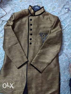 Its a raw silk indowestern suit golden color with