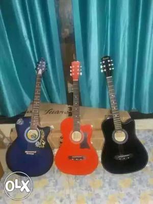 Blue, Red, And Black Acoustic Guitars