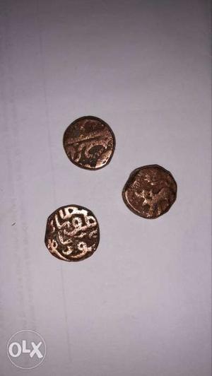 Three Round Gold-colored Mughal Coins