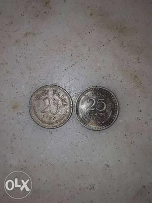 Two Round Silver-colored 25 Coins