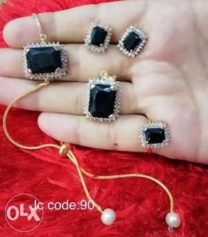 Gold-colored Earrings, Ring, And Pendant With Black And