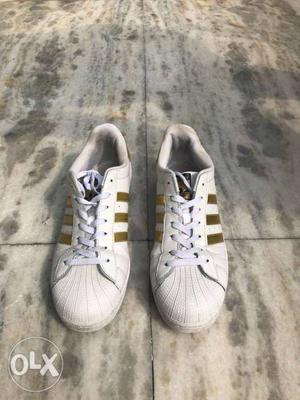 White-and-gold Adidas San Smith Sneakers