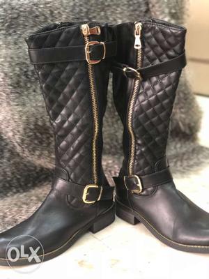 Black leather knee length boots with golden