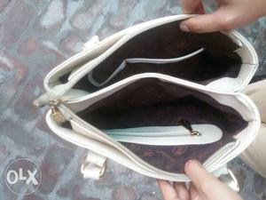Brand New. Spaller Handbag. with multi Zips and