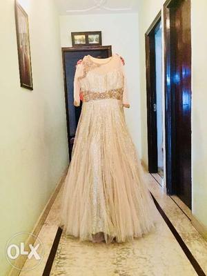 Golden coloured gown with beautiful jarkan work