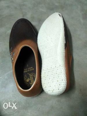 Pair Of White-and-black Slip On Shoes