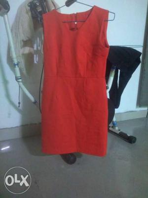 Pure red coloured dress with a zip at back side.