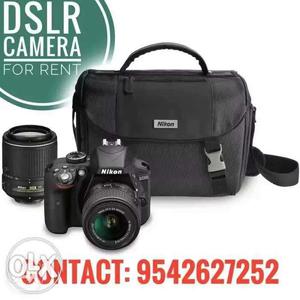 Black Nikon DSLR Camera With Zoom Lens And Bag