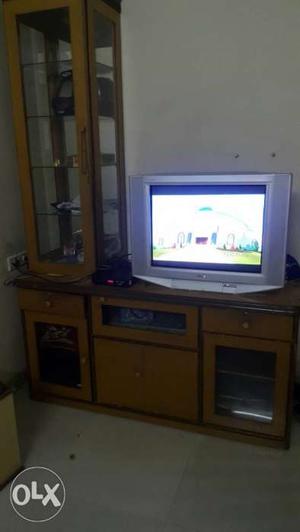 CRT Television With Brown Wooden TV Hutch