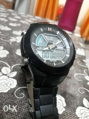 It is a Skmie Watch In Black Colour And Is In A