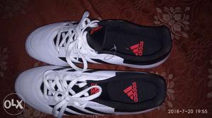 Pair Of Black-and-white Adidas Running Shoes.