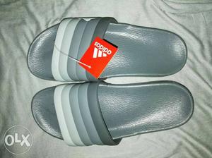 Pair Of Gray Adidas Slide Sandals
