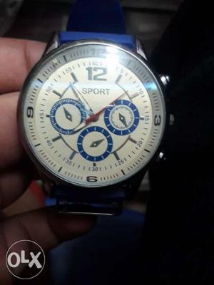 Round White Chronograph Watch With Blue Strap