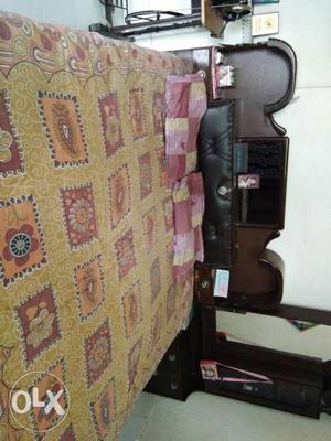 Brown Wooden Bed Frame And Yellow Floral Bed Sheet