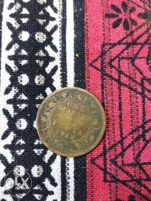 Round Gold-colored 1 Quarter Indian Coin