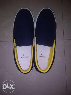 Pair Of Black-and-yellow Slip On Shoes