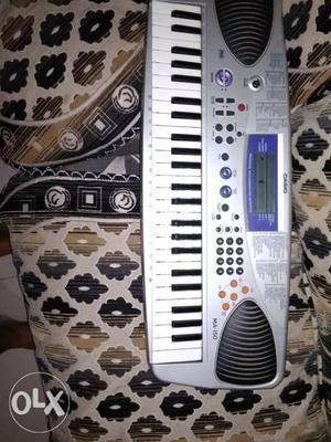 White And Gray Casio Electronic Keyboard