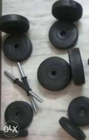 Black Weighing Plates And Silver Dumbbell Bars