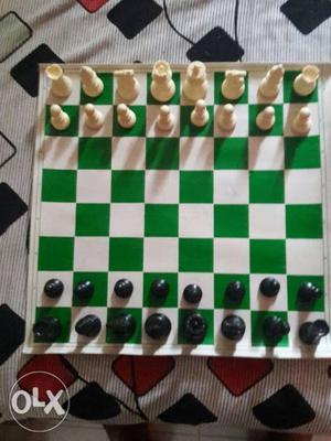 Green And White Wooden Chessboard With White And Black Chess