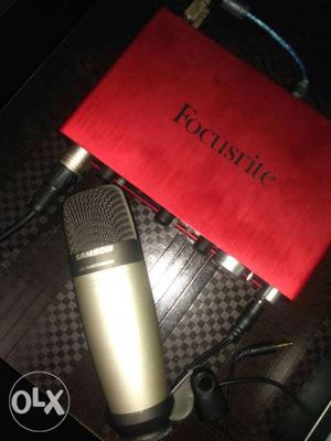 Grey Samson Condenser Microphone And Red Fucusrite Amplifer