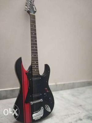 Matt black electric guitar with strap and 3 pick