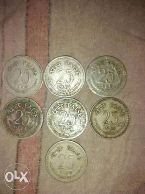 Seven Round Silver-colored 25 Indian Paise Coins