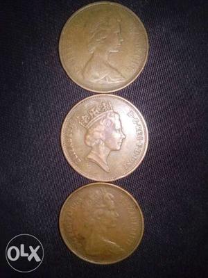 Three Round Bronze-colored Queen Elizabeth Coins
