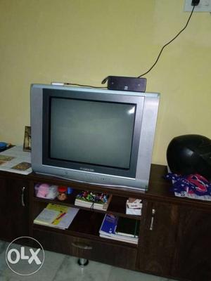 Gray CRT Television With Black Wooden TV Hutch