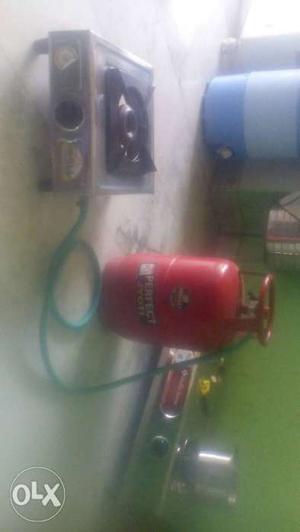 Red Propane Tank And Silver Gas Stove