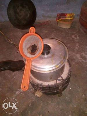 Silver Cooking Pot And Orange Strainer