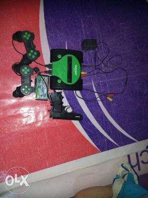 Black And Green Game Console With Controllers And Game Case