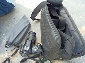 Black DSLR Camera And Black Bag