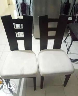 Two White Padded Brown Wooden Chairs