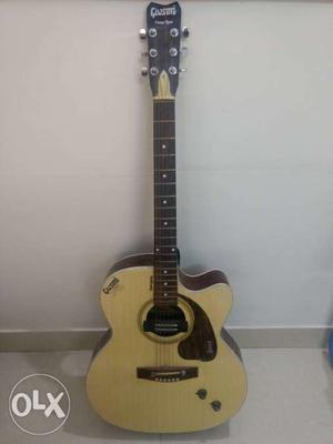 Acoustic guitar with pickup and strap