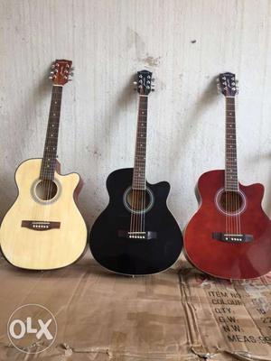 Brown, Black, And Red Cutaway Acoustic Guitars