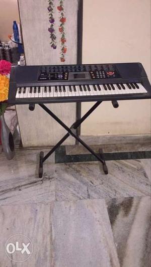 Casio music synthesizer with stand