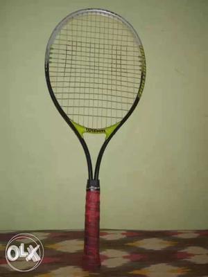Red, Black, And Green Wilson Tennis Racket