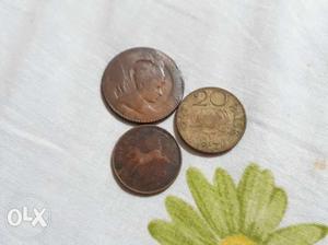 Three Round Copper-colored Indian Paise Coins