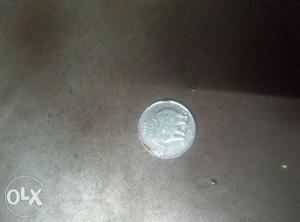 Round  Silver-colored 25 Indian Paisa Coin