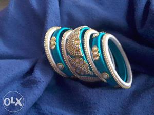 Several Teal-and-gray Bangle Bracelets