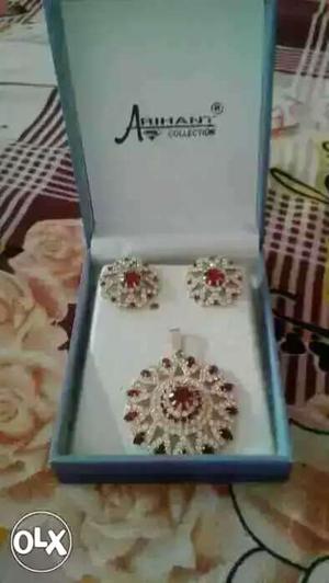Silver-colored Pendant And Earrings With Red Gemstones
