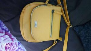 Yellow sling bag new only thrice used
