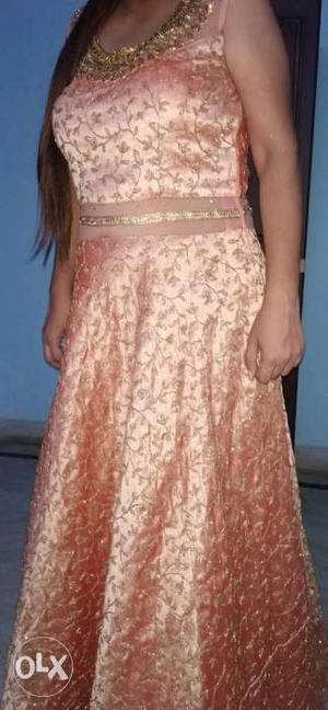 Peach colour gown with heavy golden work all over