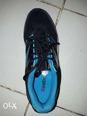 Unpaired Black And Blue Reebok Sneaker