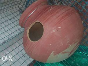 Red pot with hole for bird breeding