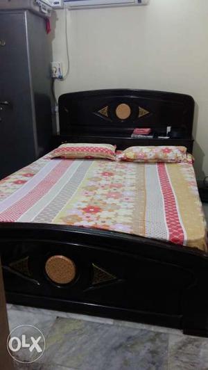 A king size bed with storage along with kurlon