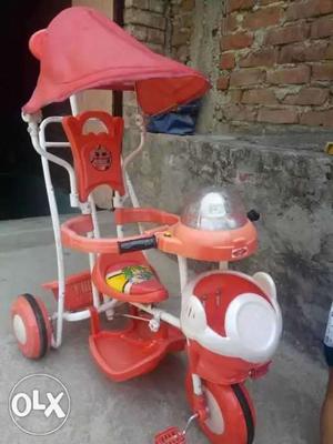 Baby's Orange And White Trike Stroller