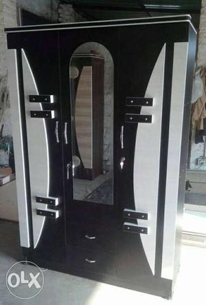 Black And White Wooden Closet With Mirror